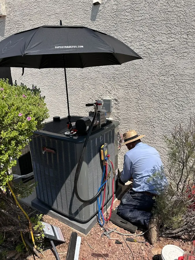 HVAC technician performing outdoor AC maintenance in Camillus